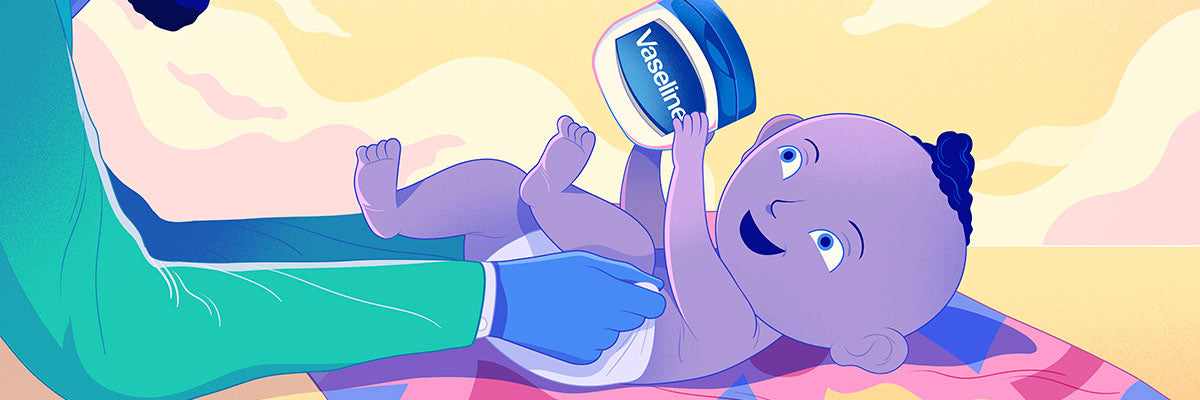 Baby getting his diaper changed while holding a jar of Vaseline.