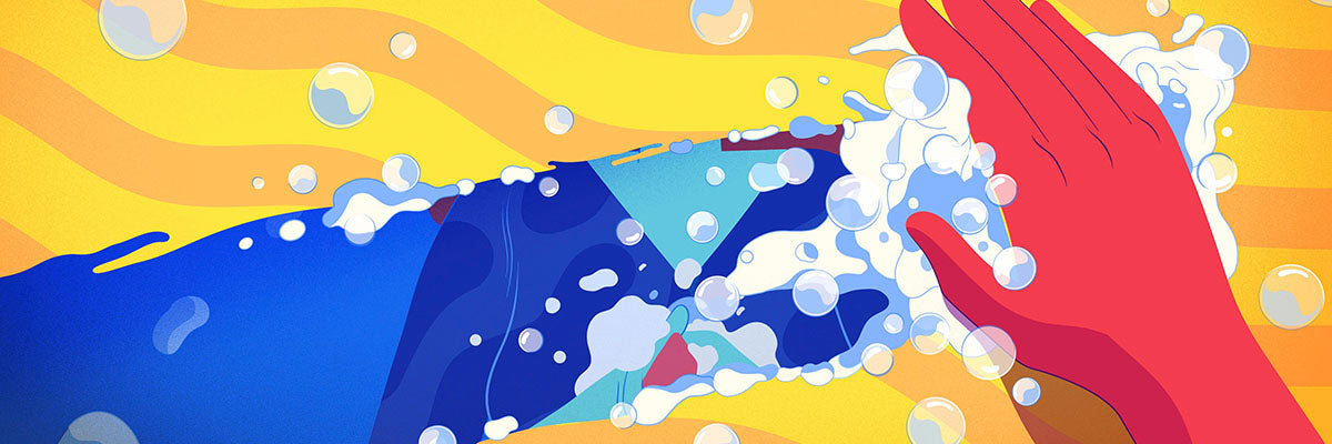 image of a hand wiping off a yellow counter with a surface wipe